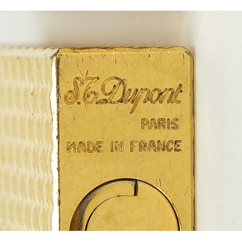 506 - Three vintage gold plated pocket lighters comprising Dunhill with fitted case, S J Dupont and Magie ... 