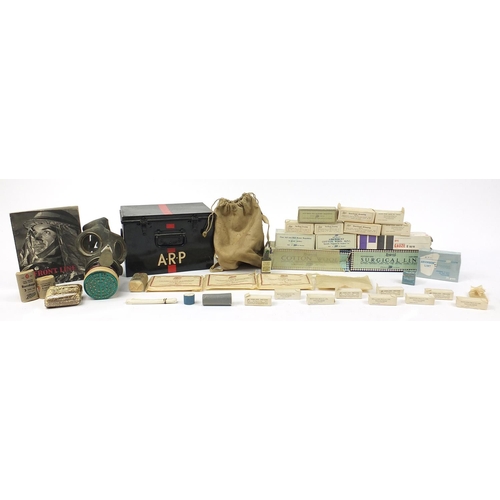 3521 - Militaria including an ARP first aid box with contents and gas mask