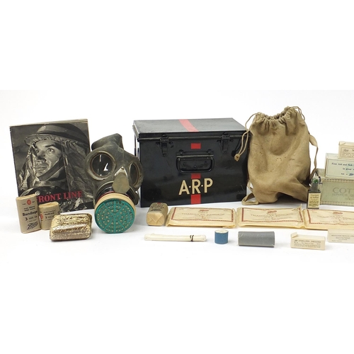 3521 - Militaria including an ARP first aid box with contents and gas mask