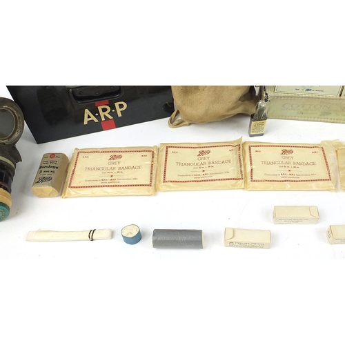 3521 - Militaria including an ARP first aid box with contents and gas mask