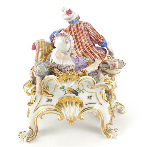 687 - Meissen, 19th century German porcelain figure group on a chaise longue, 20cm in length