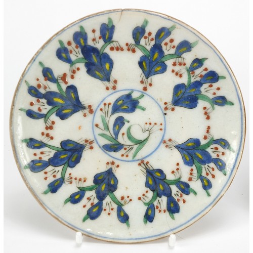 539 - Two Turkish Kutahya pottery plates hand painted with flowers, each 14.5cm in diameter