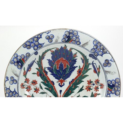 540 - Turkish Iznik pottery plate hand painted with flowers, 31cm in diameter