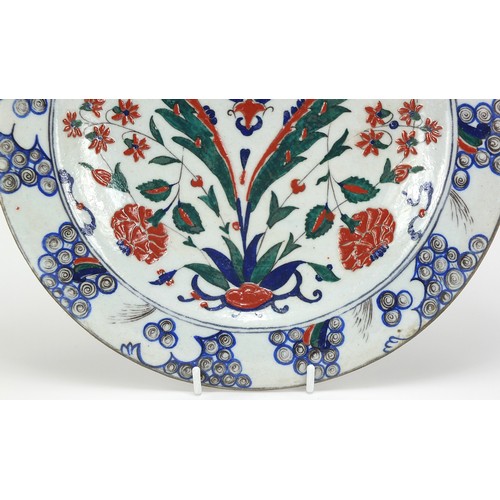 540 - Turkish Iznik pottery plate hand painted with flowers, 31cm in diameter