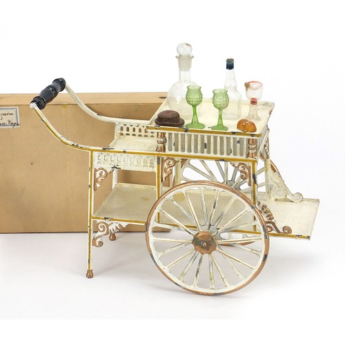1083 - 19th century German tinplate refreshment wagon with implements housed in a cardboard case including ... 
