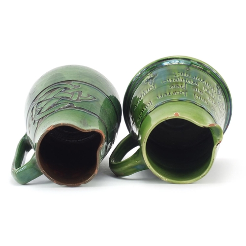 379 - C H Branham, two green glazed jugs made for Liberty & Co, the largest 19cm high