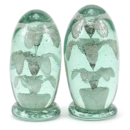 367 - Two Victorian green glass dumps with flowers to the interior, the largest 12cm high