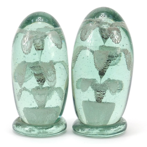 367 - Two Victorian green glass dumps with flowers to the interior, the largest 12cm high