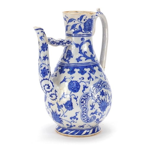 211 - Turkish Iznik pottery water carafe decorated with flowers, 29.5cm high