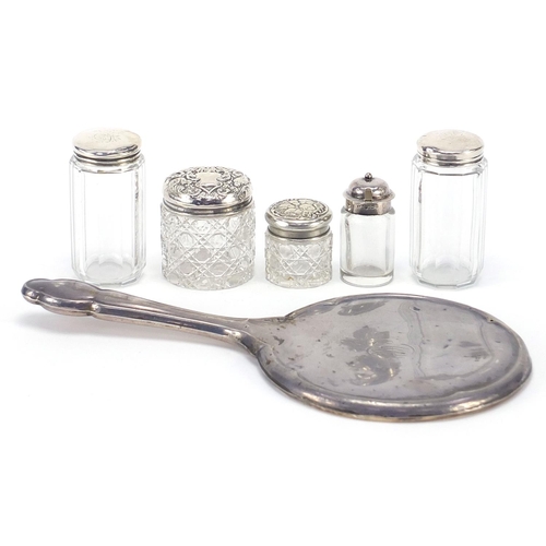1093 - Five Victorian and later silver mounted cut glass jars and a silver backed hand mirror including J &... 