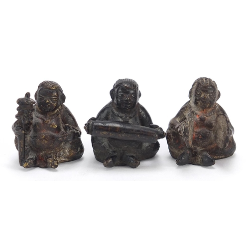 118 - Three Chinese bronzes of musicians seated playing various instruments, the largest 4cm high