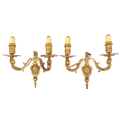 271 - Pair of French style two branch gilt metal wall sconces with masks, 29cm high x 29cm wide