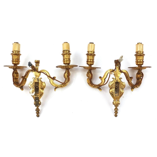 271 - Pair of French style two branch gilt metal wall sconces with masks, 29cm high x 29cm wide