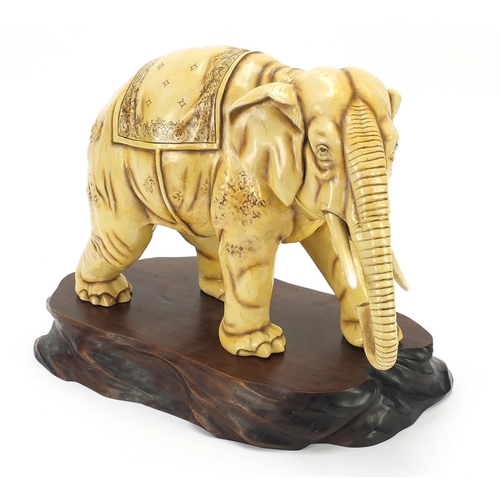 362 - Ivory coloured porcelain model of an elephant on wooden stand, blue anchor mark under one foot, lett... 