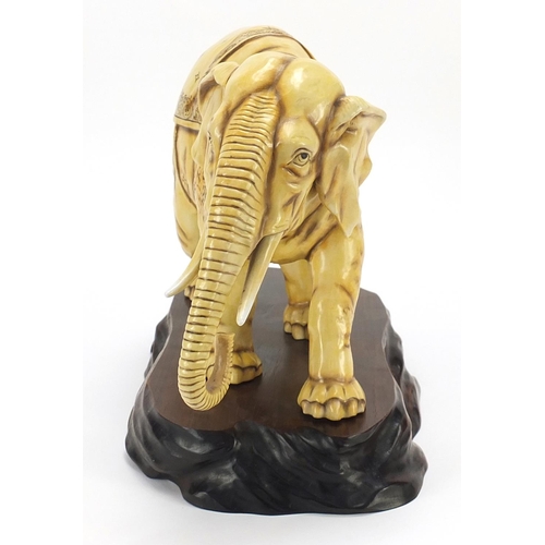 362 - Ivory coloured porcelain model of an elephant on wooden stand, blue anchor mark under one foot, lett... 