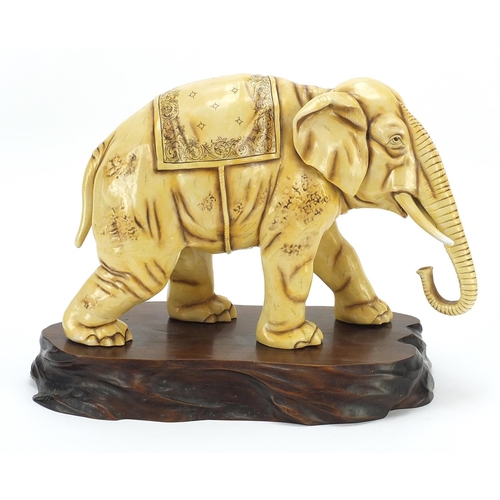 362 - Ivory coloured porcelain model of an elephant on wooden stand, blue anchor mark under one foot, lett... 