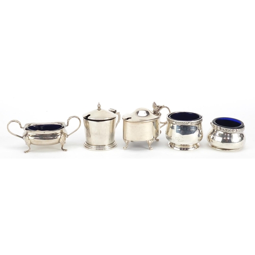 2420 - Five Edwardian and later silver cruets with blue glass liners including mustards with hinged lids, v... 