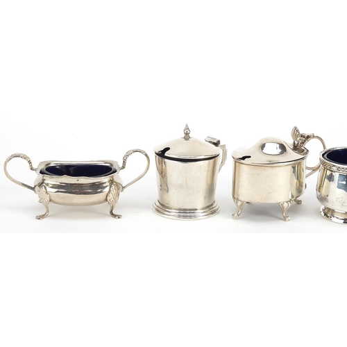 2420 - Five Edwardian and later silver cruets with blue glass liners including mustards with hinged lids, v... 