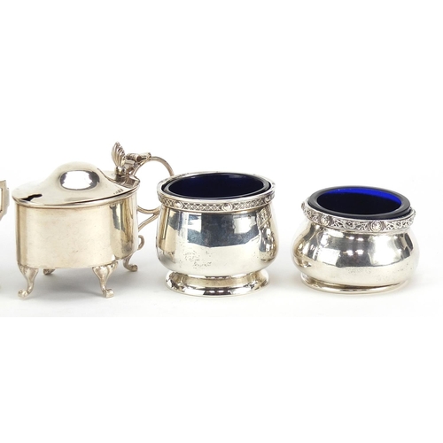 2420 - Five Edwardian and later silver cruets with blue glass liners including mustards with hinged lids, v... 