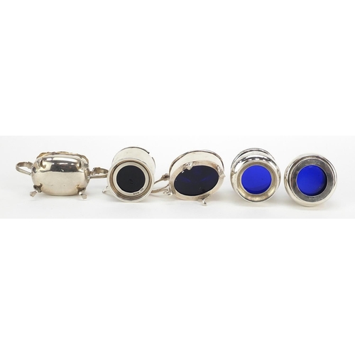 2420 - Five Edwardian and later silver cruets with blue glass liners including mustards with hinged lids, v... 