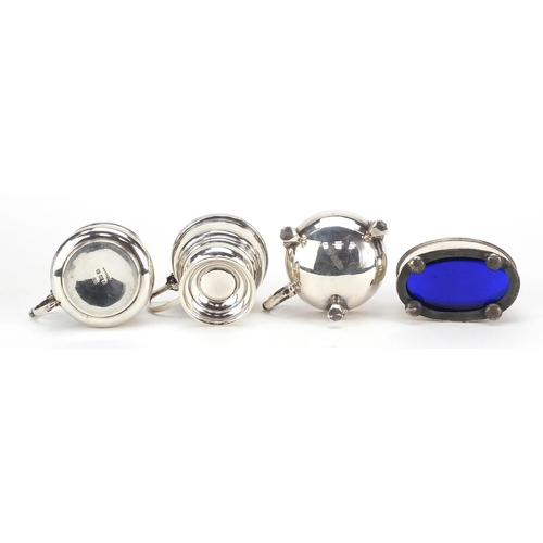 2433 - Three Edwardian and later silver mustards with hinged lids and an open salt, two with blue glass lin... 