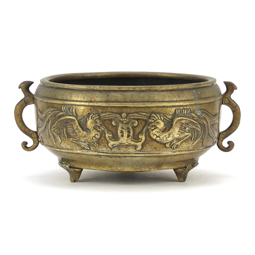 123 - Chinese patinated bronze tripod incense burner with twin handles decorated in relief with phoenixes,... 