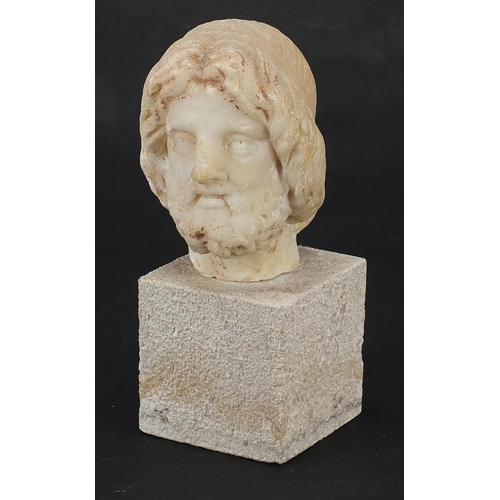 156 - Antique carved white marble bust of a bearded man raised on a square block base, possibly Roman or G... 