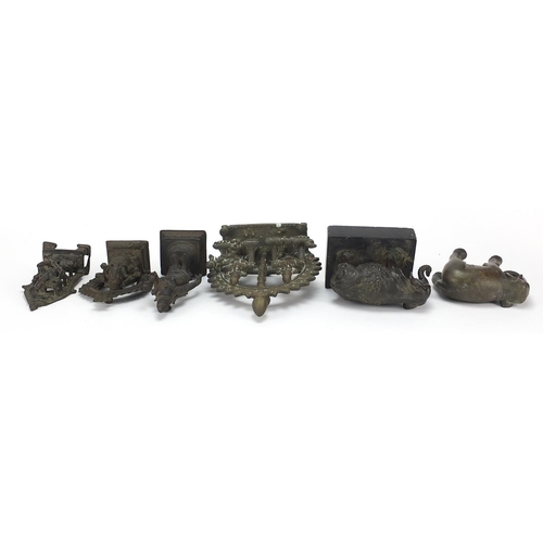 215 - Indian bronzes including votive figures and two elephants, one raised on a rectangular black slate b... 