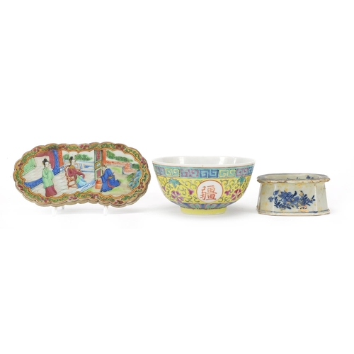 17 - Chinese porcelain comprising a Canton wrist rest, blue and white salt and a famille rose bowl, the l... 