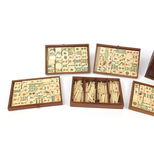 335 - Bone and bamboo Mah-jong set housed in a carved wooden box with figures and dragons