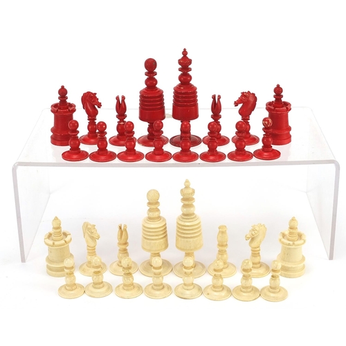 332 - Half stained carved bone chess set, the largest piece 9.5cm high