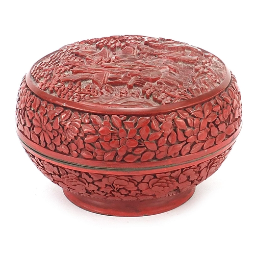 75 - Chinese cinnabar lacquer bun box and cover carved with figures amongst pagodas, 10cm high x 15cm in ... 