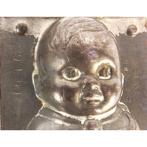 292 - Two continental cast metal chocolate moulds of children including one stamped Wein, the largest 16.5... 