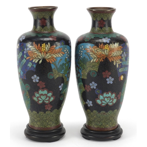 108 - Pair of Japanese cloisonne vases raised on carved hardwood stands, each enamelled with flowers withi... 