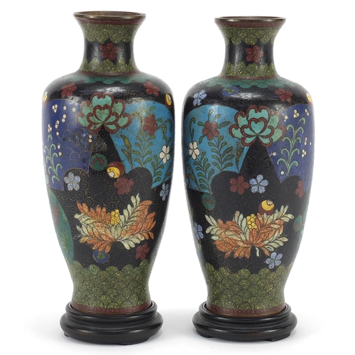 108 - Pair of Japanese cloisonne vases raised on carved hardwood stands, each enamelled with flowers withi... 