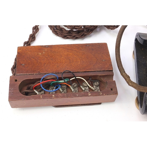 269 - Two early 20th century Ericsson no 16 dial telephones and a Elements of Telephony book, each telepho... 