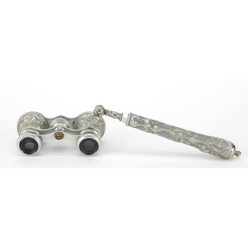 309 - Pair of white metal mounted opera glasses with side arm, 25cm wide including arm