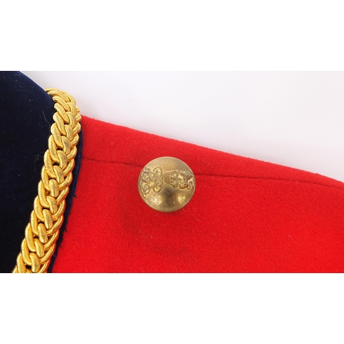 2460A - Military interest Red Life Guard's long coat with a Regimental Sergeant Major badge on the right sle... 