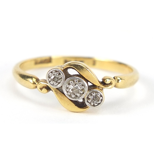 1771 - 18ct gold and platinum diamond three stone crossover ring, size N, 2.3g