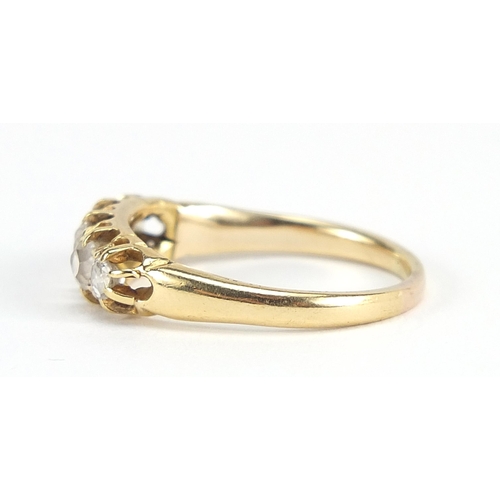 1666 - Unmarked gold graduated diamond five stone ring, the central diamond approximately 3.5mm in diameter... 