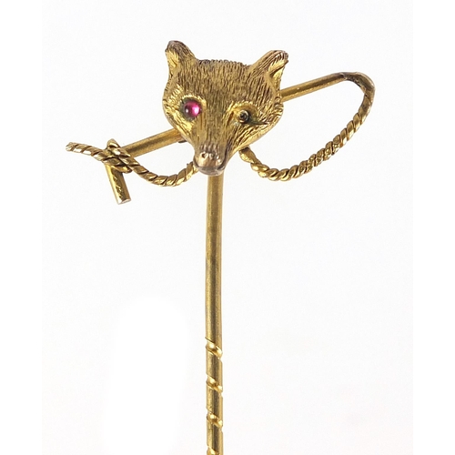 1762 - Victorian unmarked gold fox head and riding crop stick pin, 5.5cm in length, 1.4g