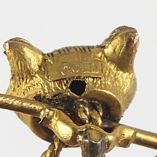 1762 - Victorian unmarked gold fox head and riding crop stick pin, 5.5cm in length, 1.4g