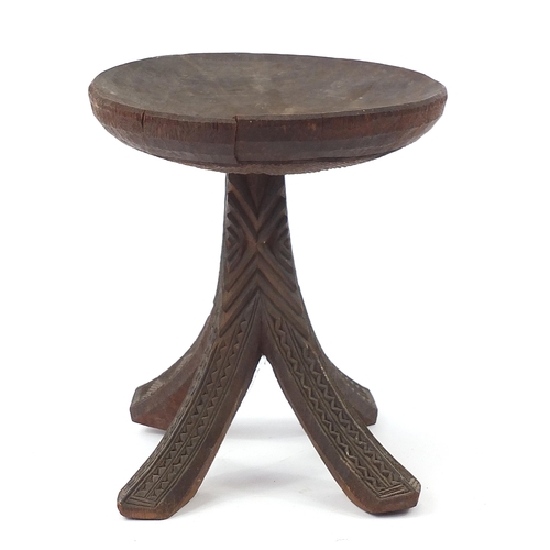 190 - African tribal interest carved stool, 34cm high x 31cm in diameter