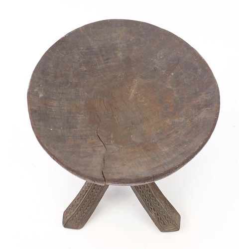 190 - African tribal interest carved stool, 34cm high x 31cm in diameter