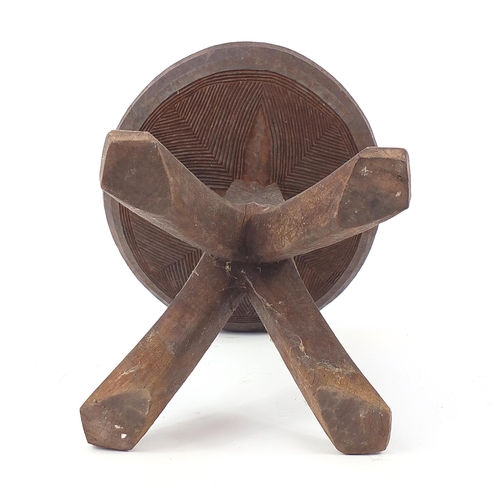 190 - African tribal interest carved stool, 34cm high x 31cm in diameter