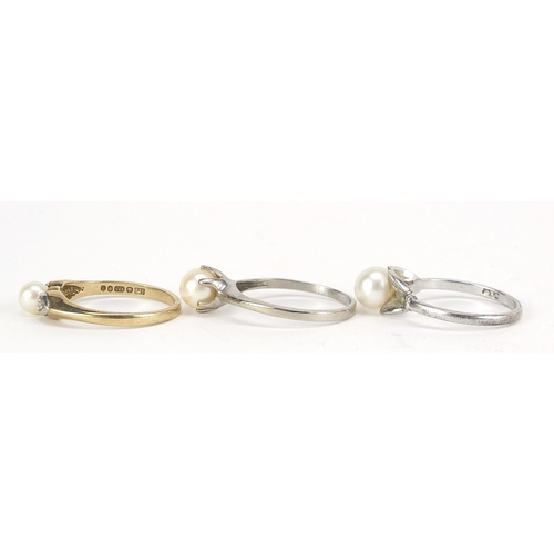 2145 - Three 9ct gold pearl rings including one with diamond shoulders, sizes L and M, total 5.6g