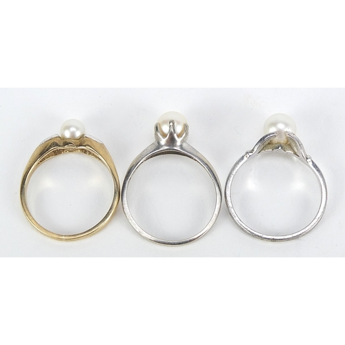 2145 - Three 9ct gold pearl rings including one with diamond shoulders, sizes L and M, total 5.6g
