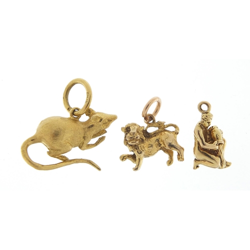 1724 - Three 9ct gold charms comprising rat, lion and nude male water carrier, the largest 2.3cm wide, tota... 