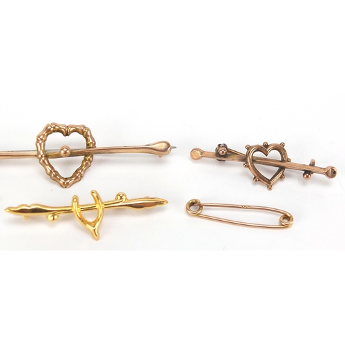 1718 - Four Victorian and later 9ct gold bar brooches comprising two love hearts and two wishbones, the lar... 