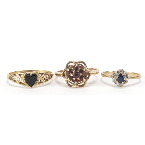 1765 - Three 9ct gold rings comprising garnet cluster, solitaire sapphire and black onyx love heart, sizes ... 